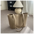 Detailed close-up of beige leather tote bag with gold logo lettering and long handles - Khaki