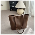 Detailed view of dark brown leather tote bag with gold stamped letters and long straps - Dark Brown