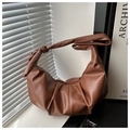 Detail of brown lychee texture leather handbag featuring pleated design and knotted strap - Brown