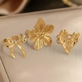 Gold stainless steel ring set featuring textured flower, heart, and bow open designs - Flower/Heart/Bow 3-Piece Set / Gold Style (F1333)