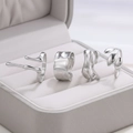 Set of four irregular stainless steel rings with hammer texture and wave designs - Silver Set (C8854)