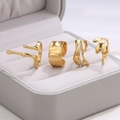 Set of four gold stainless steel rings with irregular molten lava and hammered textures - Gold Set (C8853)