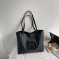 Large black tote bag with gray M-letter print and handles for shoulder carry - Black