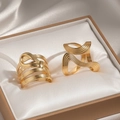 Macro shot of 18k gold plated threaded wave rings displayed on silk in a gift box - Gold Wave Multi-layer Ring Set (F935)