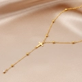 Detail of gold Y-shaped cross necklace with beads and sparkling zircon tassel on silk - Gold (C4393)