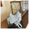 Detail of light green corduroy bag with duck patch and cute plush charm on a table - Without Pendant / Blue