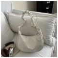 Detail of cream pleated cloud bag featuring scrunchie handle and decorative side laces - White