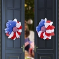 Red, white, and blue patriotic wreaths with stars hanging on a dark blue double door - Independence Day Flag Style