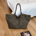 Retro leopard print tote bag with large capacity and soft canvas texture on wooden floor - Brown