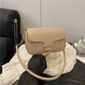 Chic beige leather shoulder bag with wavy flap design and elegant gold chain strap - Khaki
