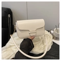 Close-up of a cream PU leather crossbody bag with elegant gold hardware and rounded handle - White