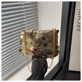 Detailed close-up of a gold sequin luxury handbag with elegant metallic chain strap - Gold