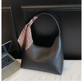 Chic black hobo shoulder bag featuring a geometric silk scarf handle and leather text detail - Black