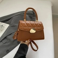 Vintage brown quilted handbag with golden teardrop buckle and adjustable strap - Brown