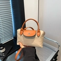 Minimalist dumpling crossbody bag in beige fabric with orange leather trim and handle - Khaki