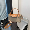Khaki nylon dumpling bag with brown leather handles and a detachable shoulder strap - Brown
