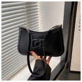 Detail of black matte faux leather baguette bag with G logo and golden metal hardware - Black