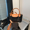 Mini black nylon dumpling bag with brown leather handles and silver snap button - Black
