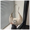 Close-up of creamy hobo bag featuring pleated texture and a sparkling rhinestone buckle - White