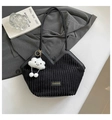 Detail of black corduroy tote bag with white cloud plush charm on a grey suit jacket - With Pendant / Black