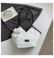 Close-up of white corduroy tote bag featuring black contrast leather trim and a smiley charm - With Pendant / White