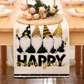Linen Happy New Year table runner detail with festive gnomes on a rustic wooden dining table - Beige New Year Gnome Style (24ZQ12-9)