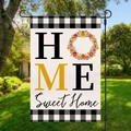 Close-up of Home Sweet Home garden flag with buffalo check borders in a green yard - Wreath Sweet Home Style (HYQ18-12)