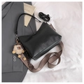 Black leather crescent bag with patterned wide strap and plush sheep charm on white fabric - With Pendant / Black