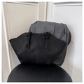 Detailed view of matte black suede wing tote bag with elegant twisted handle design - Black