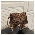 Detail of leopard print suede shoulder bag featuring long fringe and gold metal hardware - Leopard Brown