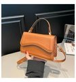 Détail d'un sac à main en similicuir marron avec rabat ondulé et boucles en métal - Marron