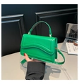 Detail of a bright green crossbody bag with wave quilted pattern and adjustable strap - Green