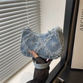Retro light blue denim hobo bag featuring distressed star patterns and frayed raw edges - Blue Star