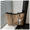 Detail of crinkled leather tote bag with contrast black straps and metal logo - Khaki With Pendant