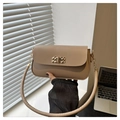 Detail of beige rectangular shoulder bag featuring a gold woven texture metal buckle - Khaki