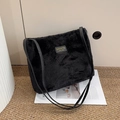Faux fur black tote bag with shoulder straps on minimalist indoor background - Black