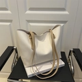 Minimalist off-white tote bag with khaki straps and Fashion & Bags text on seat - White