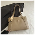 Detail of khaki tote bag featuring a decorative silk scarf and front pocket with buckle - Dark Khaki
