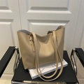 Minimalist beige PU leather tote bag with long straps on a classic chair - Khaki