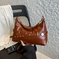 Caramel brown leather shoulder bag with adjustable strap and golden metal eyelets - Brown