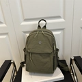 Lightweight olive green nylon backpack with front pocket and round metal logo - Green