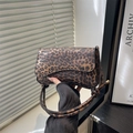 Chic leopard print crossbody bag with knotted strap detail and elegant leather flap - Brown