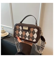 Close-up of Argyle pattern plaid handbag with wide wavy strap and golden hardware - Brown