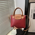 Red woven texture tote bag with brown leather handles and adjustable shoulder strap - Red