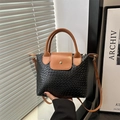 Chic two-tone black woven leather handbag with brown handles and crossbody strap - Black