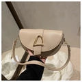 Dettaglio borsa a sella beige in pelle liscia con chiusura in metallo dorato a triangolo - Kaki
