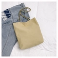 Detailed view of canvas tote bag featuring colorful beaded handle and gold lettering - Yellow