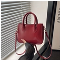 Detail of red synthetic leather mini tote bag with adjustable strap and gold metal buckle - Red