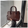 Detail of dark brown retro tote bag featuring smooth PU leather and gold hardware - Brown