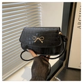 Elegant black crocodile pattern crossbody bag with a gold bow accent and leather strap - Black